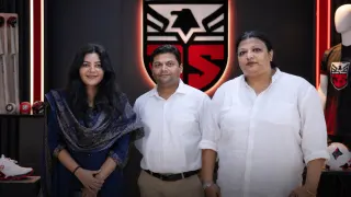 YourStory founder Shradha Sharma standing alongside Java Sports co-founders Nishant Ranjan and Trina Mukherjee
